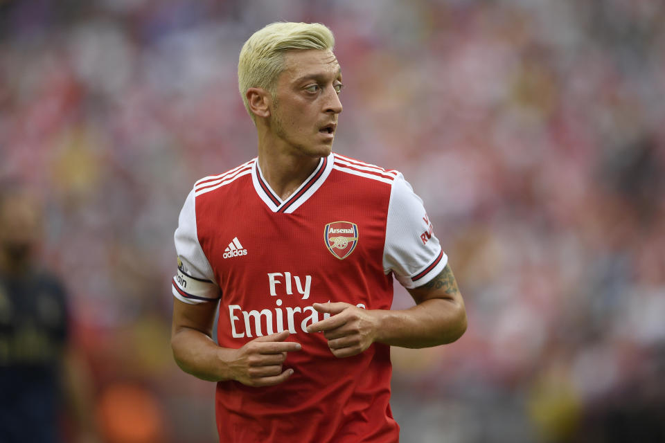 Arsenal midfielder Mesut Ozil stands on the field during the first half of an International Champions Cup soccer match against Real Madrid, Tuesday, July 23, 2019, in Landover, Md. (AP Photo/Nick Wass)