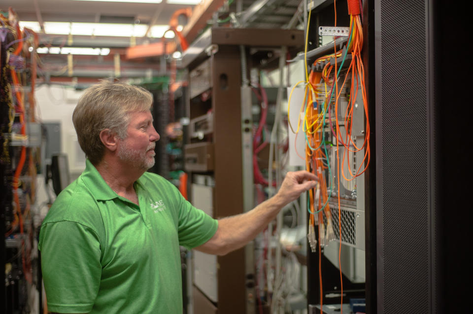 BROKEN BOW, OK - OCTOBER 2: Jerry Wisenhunt, general manager for Pine Cellular, looks through cabinets of Huawei equipment at his company headquarters in Broken Bow, Oklahoma on October 2, 2019. (Photo by Joseph Rushmore for The Washington Post via Getty Images)