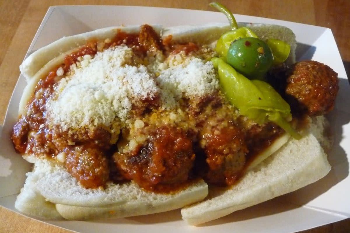 The Meatball Sandwich in a white paper boat, Caputo's Market & Deli, Salt Lake City, on a wooden table