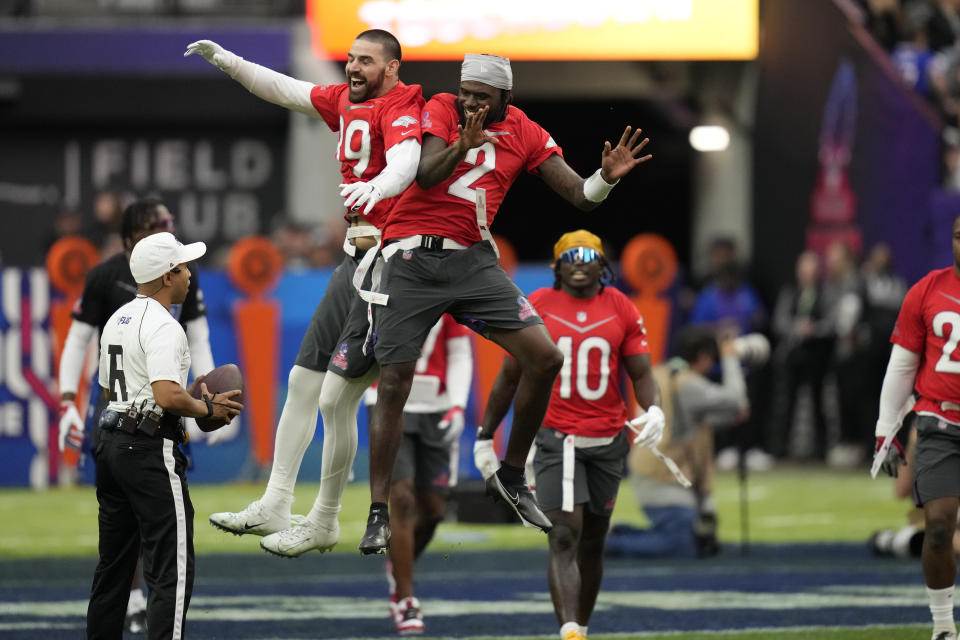 AFC tight end Mark Andrews (89) of the Baltimore Ravens, left, celebrates a touchdown with teammate AFC quarterback Tyler Huntley (2) of the Baltimore Ravens during the flag football event at the NFL Pro Bowl, Sunday, Feb. 5, 2023, in Las Vegas. (AP Photo/John Locher)