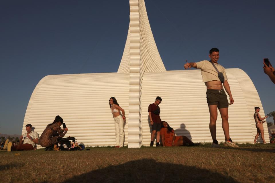 People pose for photos as the sun sets.