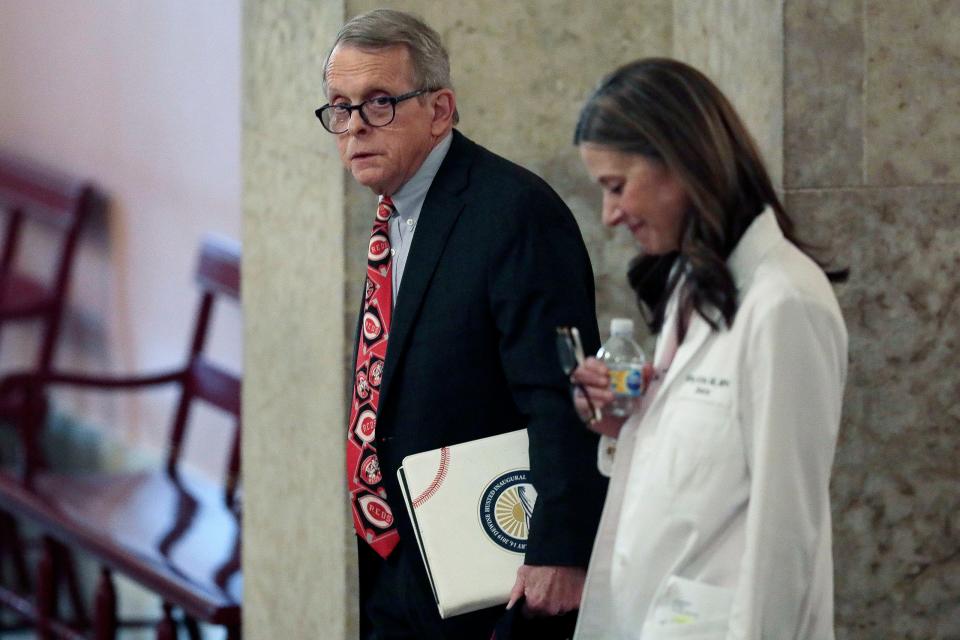 Ohio Gov. Mike DeWine and Dr. Amy Acton, director of the Ohio Department of Health, prepare to deliver a daily coronavirus briefing on March 26, 2020, in Columbus.