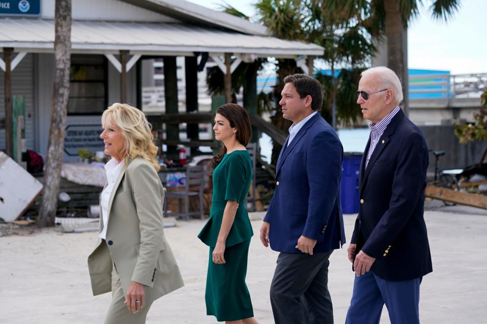 President Joe Biden, right, and first lady Jill Biden, left, tour an area impacted by Hurricane Ian with Florida Gov. Ron DeSantis, second from right, and his wife Casey DeSantis on Wednesday, Oct. 5, 2022, in Fort Myers Beach, Fla.