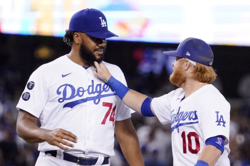 The Dodgers' Justin Turner, right, playfully yanks the beard of Kenley Jansen after the Dodgers beat the Colorado Rockies.