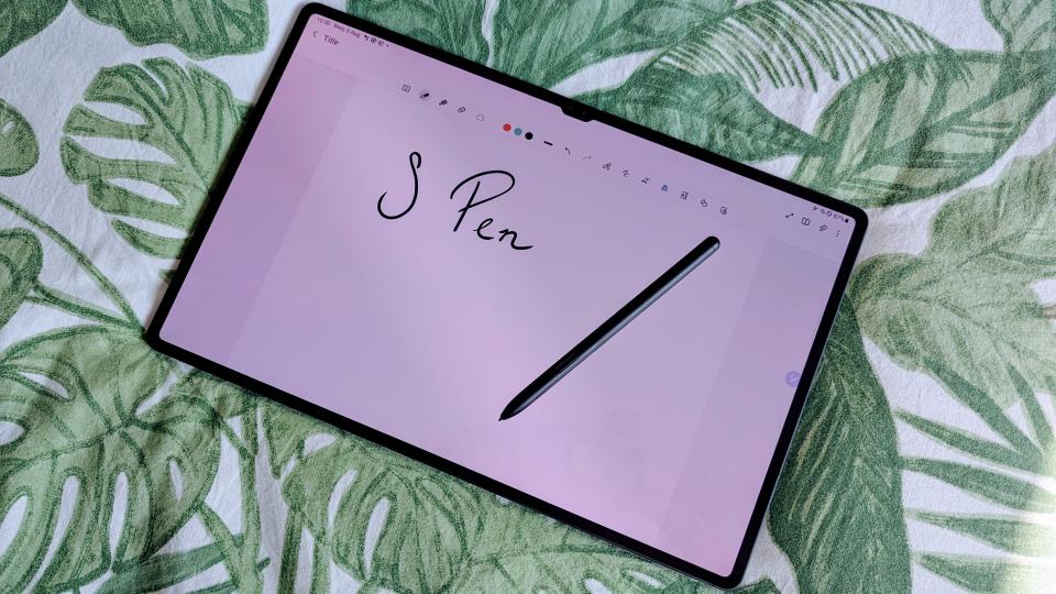 Samsung Galaxy Tab S9 Ultra 5G with stylus on top and a note open