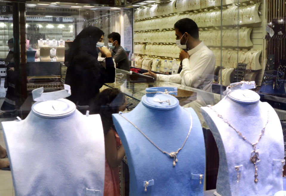 Saudis buy jewels at the gold market a day before the expected increase of VAT from 5% to15%, in Jiddah, Saudi Arabia, Tuesday, June 30, 2020. (AP Photo/Amr Nabil)