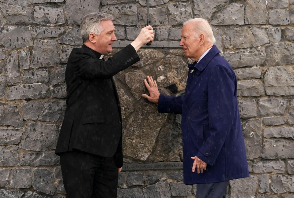 Joe Biden touches the original gable wall of the church at the Knock Shrine (REUTERS/Kevin Lamarque)