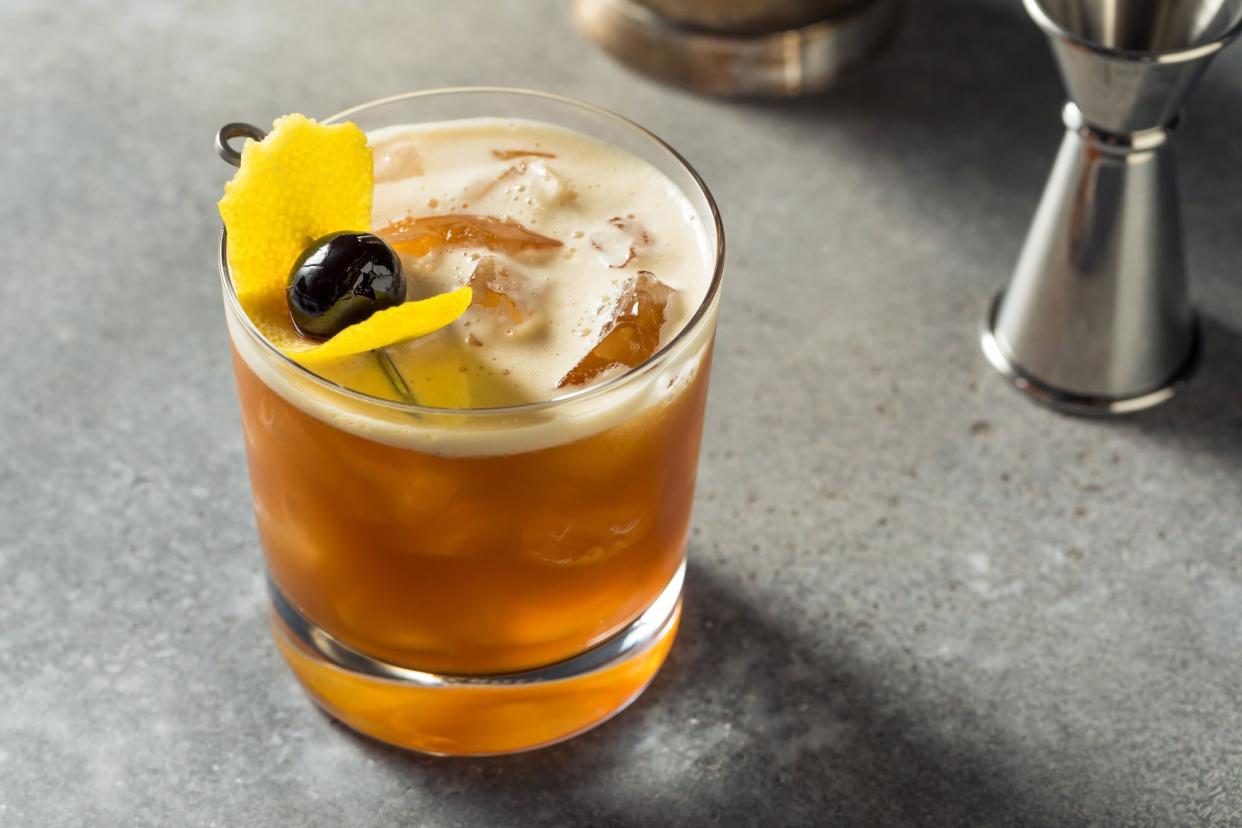 Cold Amaro Sour cocktail with lemon garnish