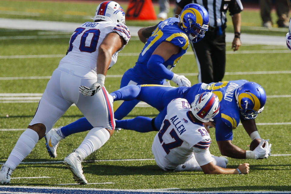 Los Angeles Rams' Aaron Donald recovers the ball after sacking Buffalo Bills' Josh Allen (17) during the second half of an NFL football game Sunday, Sept. 27, 2020, in Orchard Park, N.Y. (AP Photo/John Munson)