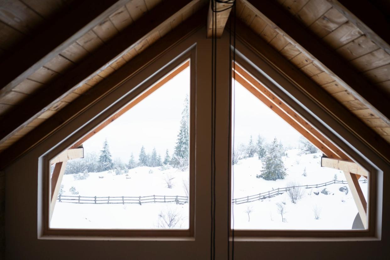 attic-window-looking-out-on-snowy-hillside