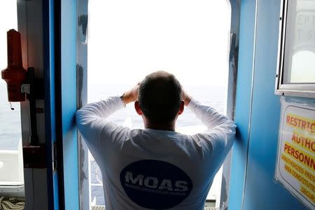 A crew member on the Migrant Offshore Aid Station (MOAS) ship Topaz Responder keeps a look out for migrants in distress in international waters off the coast of Libya, June 21, 2016. REUTERS/Darrin Zammit Lupi
