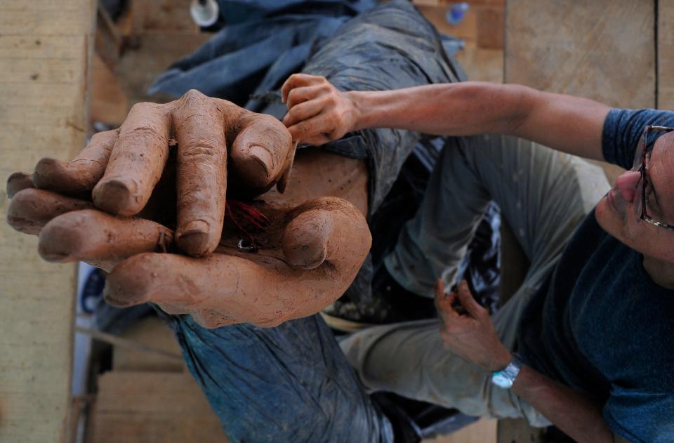 Picture taken on August 25, 2023, of Colombian artist Yino Marquez working in a statue of Colombian singer Shakira in Barranquilla, Colombia. Colombian superstar Shakira's Caribbean home city of Barranquilla unveiled a 6.5-meter (21.3-foot) hip-swaying statue in her honor on Tuesday.