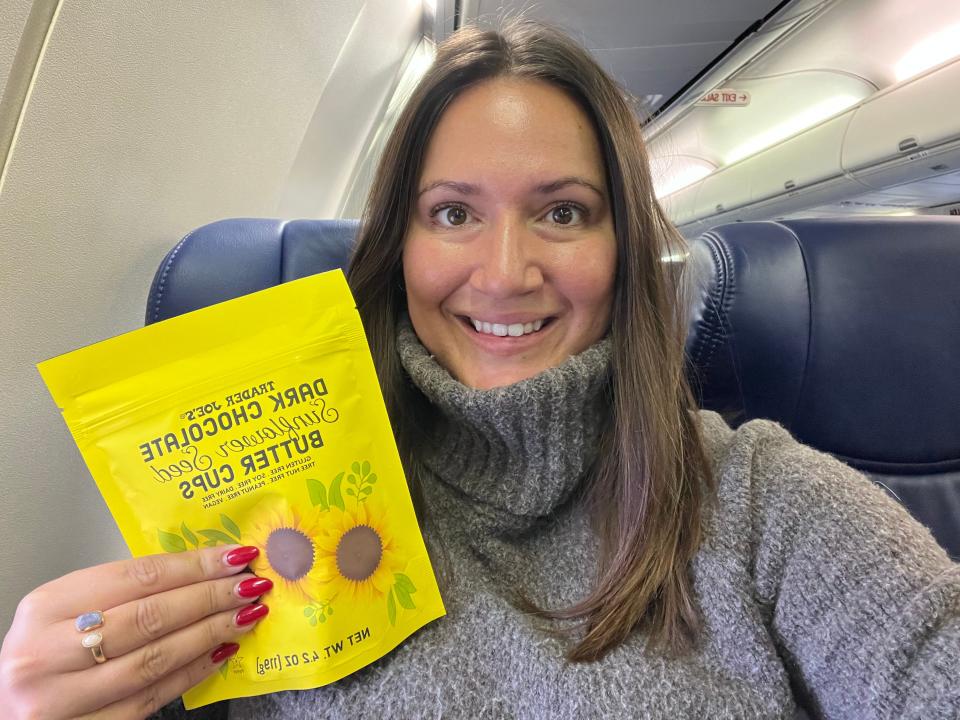 The writer holds a bag of Trader Joe's dark-chocolate sunflower-seed-butter cups on a plane