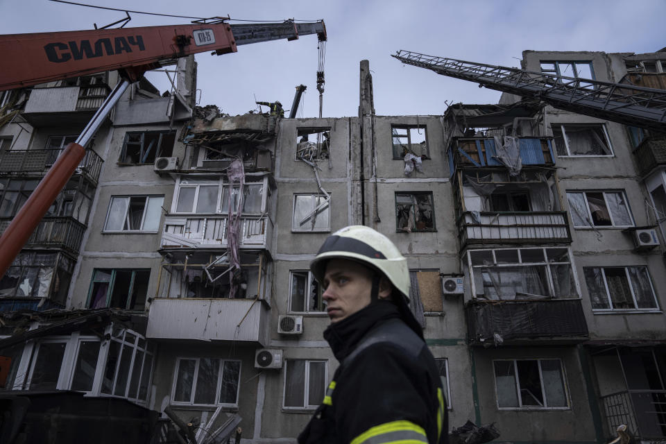 Rescue workers clear the rubble of the residential building which was destroyed by a Russian rocket in Pokrovsk, Ukraine, Wednesday, Feb. 15, 2023. According to local authorities, 2 people were killed and 12 injured. (AP Photo/Evgeniy Maloletka)