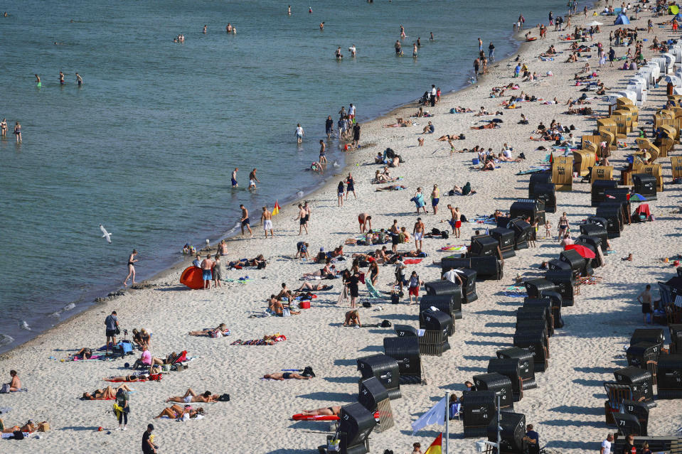 Vacationers and day visitors enjoy this Baltic Sea beach near Scharbeutz, while large parts of southern Europe are suffering from forest fires, droughts and extreme temperatures. - Credit: Christian Charisius/picture-alliance/dpa/AP Images