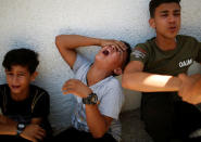 Relatives of a Palestinian, who was killed at the Israel-Gaza border, react at a hospital in Gaza City June 18, 2018. REUTERS/Mohammed Salem