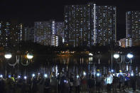 Activists wear masks and hold up their mobile phone lights during a protest in Hong Kong, Friday, Oct. 18, 2019. Hong Kong pro-democracy protesters are donning cartoon/superhero masks as they formed a human chain across the semiautonomous Chinese city, in defiance of a government ban on face coverings. (AP Photo/Vincent Yu)