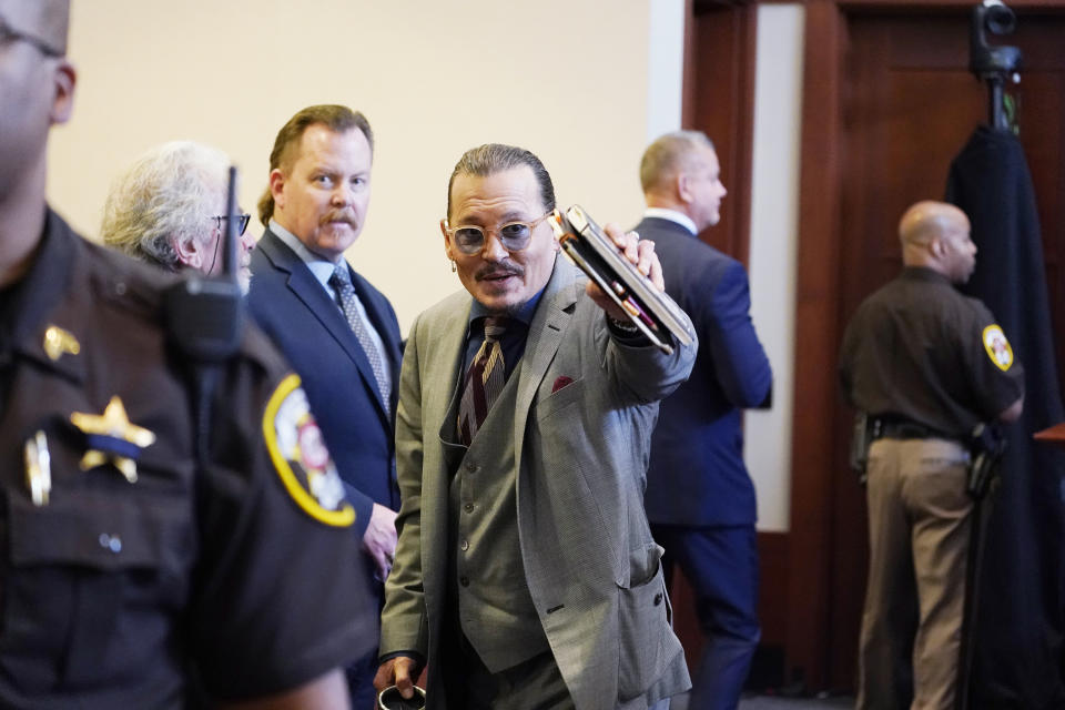 Actor Johnny Depp looks toward the courtroom gallery as they take a break in the courtroom at the Fairfax County Circuit Courthouse in Fairfax, Va., Monday, May 16, 2022. Depp sued his ex-wife Amber Heard for libel in Fairfax County Circuit Court after she wrote an op-ed piece in The Washington Post in 2018 referring to herself as a "public figure representing domestic abuse." (AP Photo/Steve Helber, Pool)