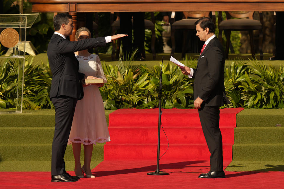 Paraguay's new President Santiago Pena, left, takes the oath of office, officiated by Congress President Silvio Ovelar on his inauguration day in Asuncion, Paraguay, Tuesday, Aug. 15, 2023. (AP Photo/Jorge Saenz)