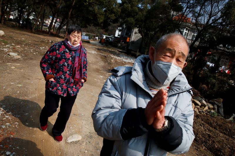 Man wears a face mask in a village outside Donglin Temple that is under lockdown because of the coronavirus outbreak in Jiujiang