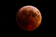 <p>This picture shows the full moon during a “blood moon” eclipse as seen from the town of Kazanlak, some 100 km northwest of Plovdiv, on July 27, 2018. (Photo: Dimitar Dilkoff/AFP/Getty Images) </p>