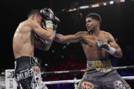 Shakur Stevenson, right, throws a punch at Oscar Valdez during a WBC-WBO junior lightweight title boxing bout Saturday, April 30, 2022, in Las Vegas. (AP Photo/John Locher)