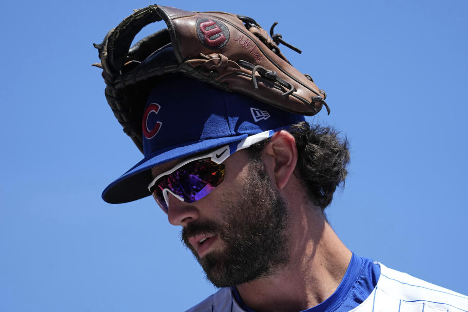 Chicago Cubs' Dansby Swanson looks down as he autographs for fans before a baseball game against the Cincinnati Reds in Chicago, Sunday, June 2, 2024. (AP Photo/Nam Y. Huh)