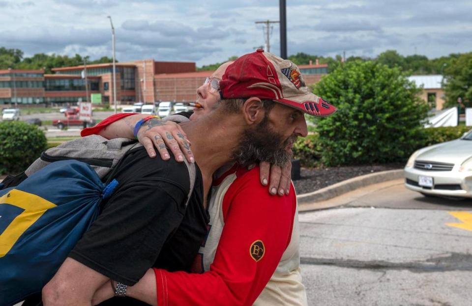 Ken Simard, left, hugs Lulu Livingston. Livingston is a long time friend of Simard and provided him with temporary housing after he was shot. Zachary Linhares/zlinhares@kcstar.com