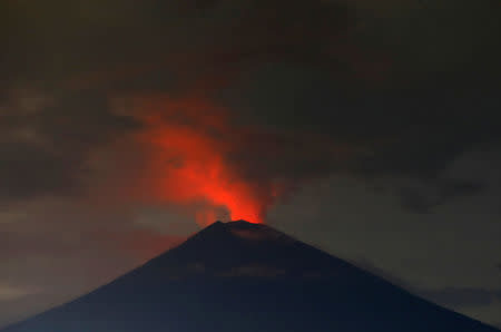 Lava, inside the crater of Mount Agung volcano, reflects off ash and clouds, while it erupts, as seen from Amed, Karangasem Regency, Bali, Indonesia November 30, 2017. Picture taken with long exposure. REUTERS/Darren Whiteside