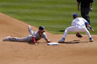 Washington Nationals' Trea Turner, left, dives into second on a wild pitch as Los Angeles Dodgers second baseman Gavin Lux takes a late throw from home during the sixth inning of a baseball game Sunday, April 11, 2021, in Los Angeles. (AP Photo/Mark J. Terrill)