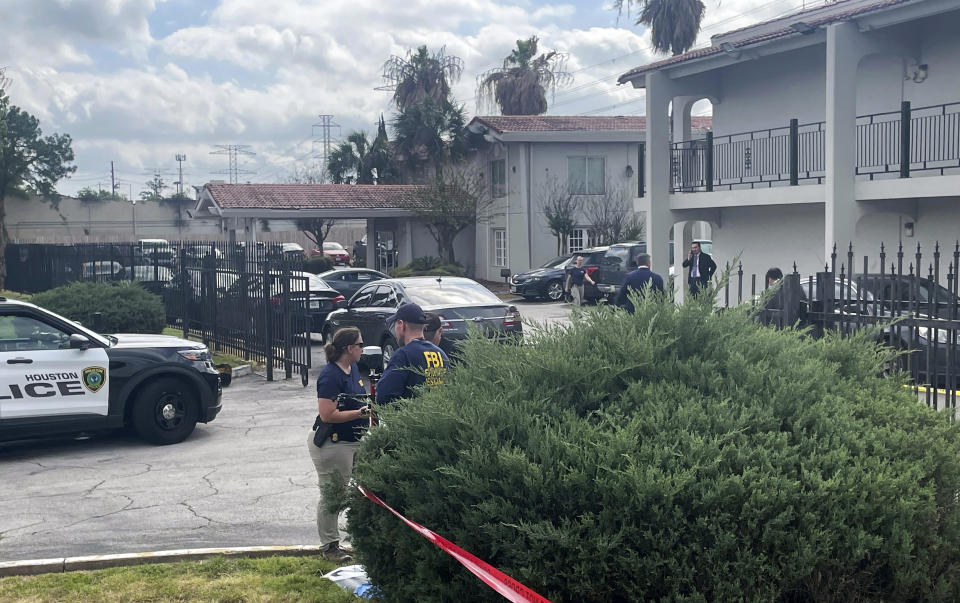 FILE - The FBI works on the scene of a shooting on March 23, 2023, in north Houston. A second teenager has been charged with kidnapping several migrants and allegedly holding them captive for several days at a Houston hotel before they were rescued by FBI agents during a confrontation that ended with the fatal shooting of another suspect, authorities said Monday, April 17. (Ralph Green/Houston Chronicle via AP, File)