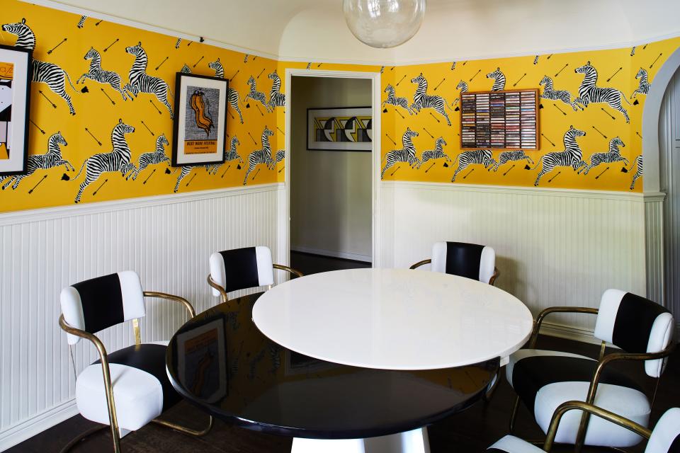 A look at Ronson’s breakfast nook in the home’s spacious kitchen. The iconic Scalamandre zebra wallpaper, here in yellow, is another nostalgic nod to the musician’s childhood. The same print, though in Masai Red, hung in one of the Ronson family’s go-to restaurants in New York City: the since-closed Gino of Capri that used to sit across from then white-hot Bloomingdale’s. “It reminds me of my youth,” says Ronson. “And it’s also in Woody Allen’s Manhattan.” Another relic made relevant? The collection of cassettes boxed and displayed on the kitchen wall. “These are all my favorite albums, but on cassette,” he explains. “Everything from the B-52s to Pete Rock to Sly and the Family Stone.” Through the door, one gets a glimpse of an early print by Lichtenstein, which “accidentally" complements the wallpaper. “It’s weird,” he notes, “but if you squint your eyes and look at [the print], it also looks like zebras bouncing through the air.”