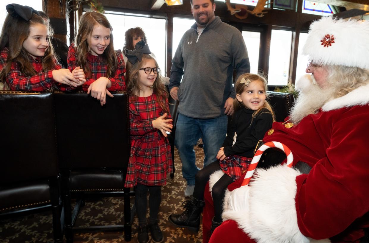 Children gather around Santa Claus at Big Cedar Lodge in Ridgedale.