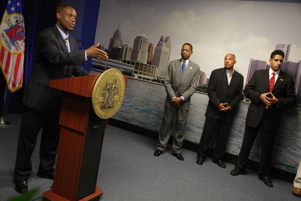 Detroit Emergency Financial Manager Kevyn Orr, left announces that he filled for municipal bankruptcy during a press conference at the Coleman A. Young municipal building in Detroit on July 18, 2013.