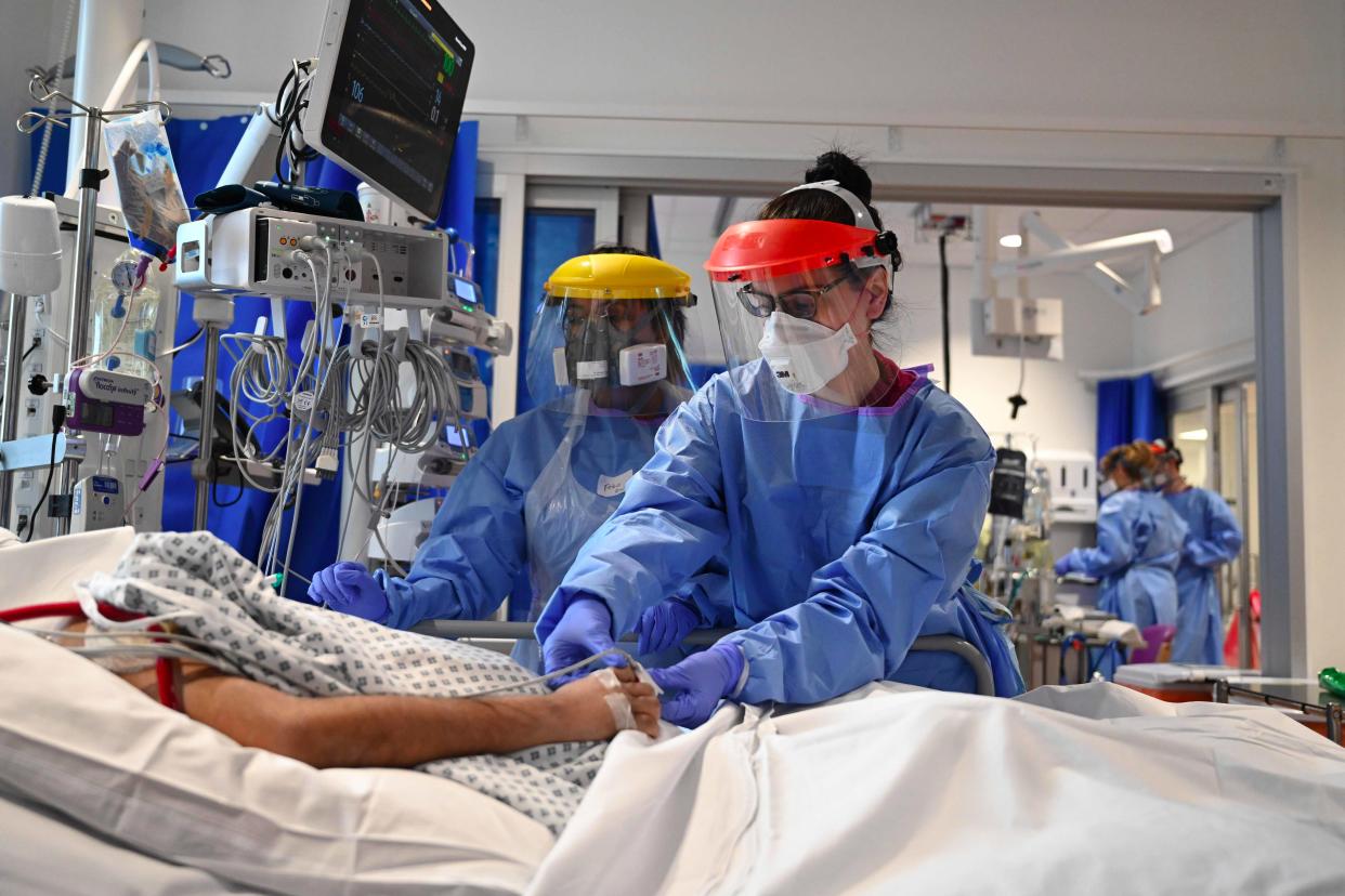 <p>Staff treat a patient on an intensive care ward.</p> (AFP/Getty)