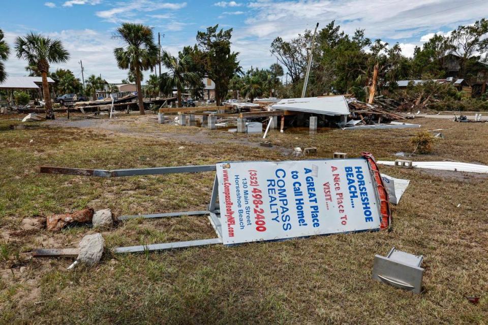 A realty sign promoting homes for sale is among the litter left behind on Thursday, August 31, 2023, after Hurricane’s Idalia storm surge hit in Horseshoe Beach, Florida.