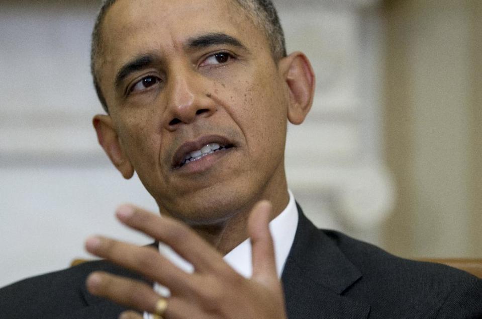 President Barack Obama gestures as he speaks to the media during a photo opportunity with Haiti President Michel Martelly in the Oval Office of the White House in Washington, Thursday, Feb. 6, 2014. (AP Photo/Carolyn Kaster)