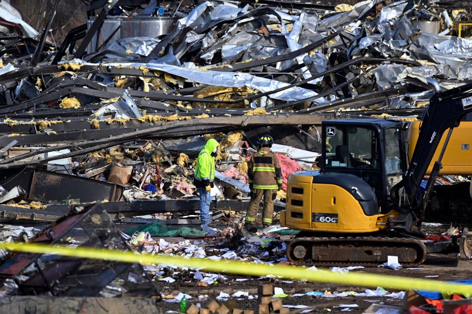 Emergency response workers dig through the rubble of the Mayfield Consumer Products candle factory in Mayfield, Ky., Saturday, Dec. 11, 2021. Tornadoes and severe weather caused catastrophic damage across multiple states late Friday, killing several people overnight. (AP Photo/Timothy D. Easley)