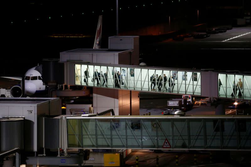 FILE PHOTO: People disembark from an aircraft at Heathrow Airport in London