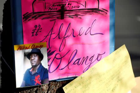 A photo of Alfred Olango, who was shot by El Cajon police, is seen at a makeshift memorial at the parking lot where he was shot in El Cajon, California, U.S. September 29, 2016. REUTERS/Patrick T. Fallon