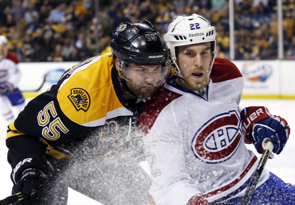 Boston Bruins defenseman Johnny Boychuk (55) checks Montreal Canadiens right wing Dale Weise (22) during the first period in Game 1 of an NHL hockey second-round playoff series in Boston, Thursday, May 1, 2014. (AP Photo/Elise Amendola)