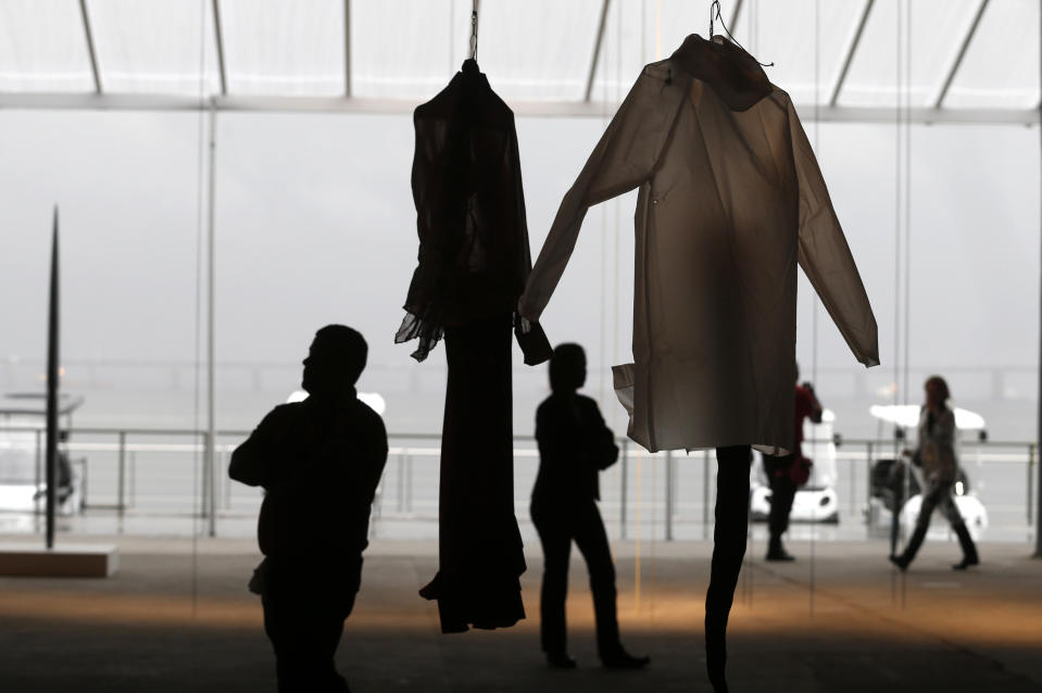 People look at artwork by Annette Messager during a private viewing at the ART Rio-International Art Fair in Rio de Janeiro, Brazil, Wednesday, Sept. 4, 2013. Over 100 galleries from more than a dozen countries are taking part in the five-day event, which opens on Thursday to the general public. (AP Photo/Silvia Izquierdo)