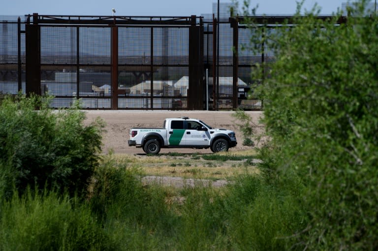 US Border Patrol agents patrol the bed of the Rio Grande river in front of housing for underage people caught illegally entering the United States from Mexico at the Tornillo Port of Entry
