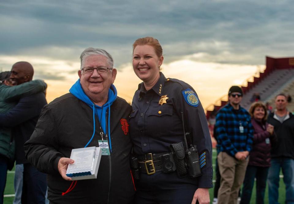 Sacramento high school football coaching legend Max Miller receives a Pig Bowl Hall of Fame plaque from Sacramento Police Chief Kathy Lester during halftime of the 50th Pig Bowl on Saturday. Nathaniel Levine/nlevine@sacbee.com