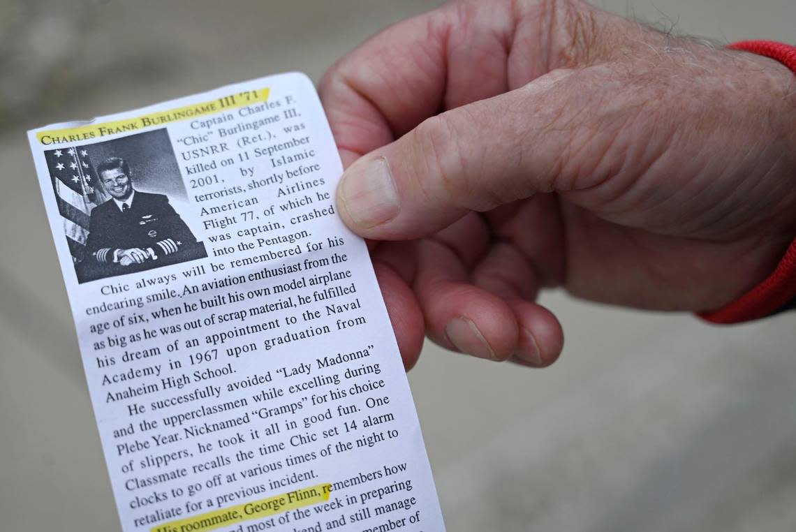 George Flinn of Overland Park displays a clipping featuring his former roommate, Capt. Charles ‘Chic’ Burlingame III, the pilot of Flight 77, the hijacked Boeing 757, that crashed into the Pentagon on Sept. 11, 2001. Flinn paid his respects Monday, Sept. 11, the 22nd anniversary of the 9/11 terrorist attacks, during a ceremony at 9/11 Memorial in Overland Park. Flinn and Burlingame were roommates at the U.S. Naval Academy where they both graduated in 1971.