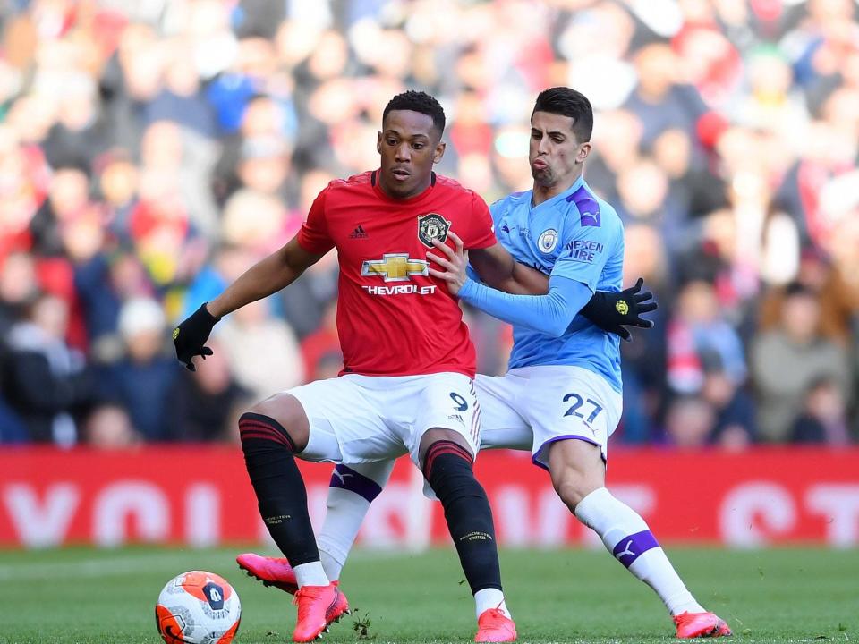 Martial controls the ball under pressure from Cancelo: Getty