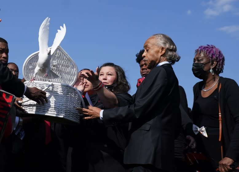 MINNEAPOLIS April 22, 2021.Daunte Wright's funeral came just days after a Minneapolis jury convicted another white former police officer. Katie Wright released doves after the funeral, beside her is Rev. Al Sharpton.