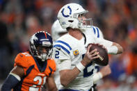 Indianapolis Colts quarterback Matt Ryan (2) looks to throw under pressure from Denver Broncos cornerback K'Waun Williams (21) during the second half of an NFL football game, Thursday, Oct. 6, 2022, in Denver. (AP Photo/David Zalubowski)