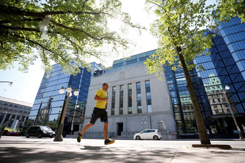 FILE PHOTO: A jogger runs past the Bank of Canada building in Ottawa