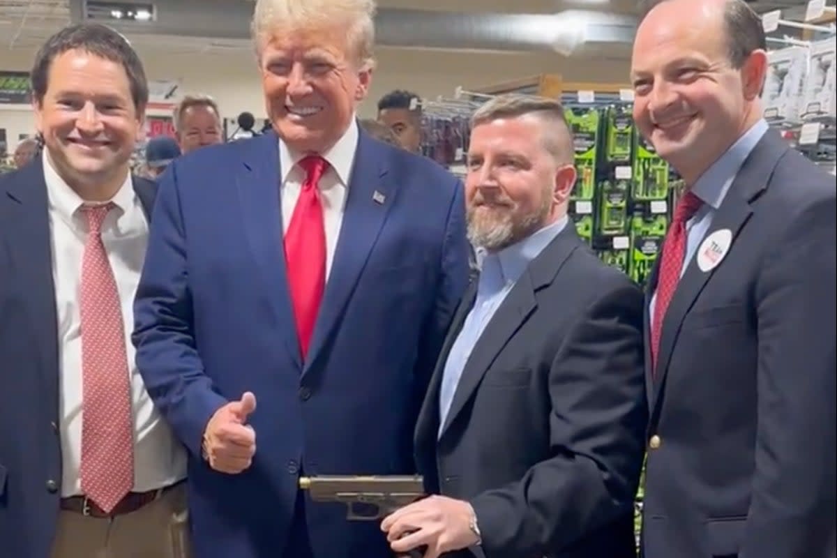 Donald Trump poses with South Carolina Attorney General Alan Wilson, right, at a gun store in South Carolina on 25 September. (Steven Cheung/Donald Trump campaign)